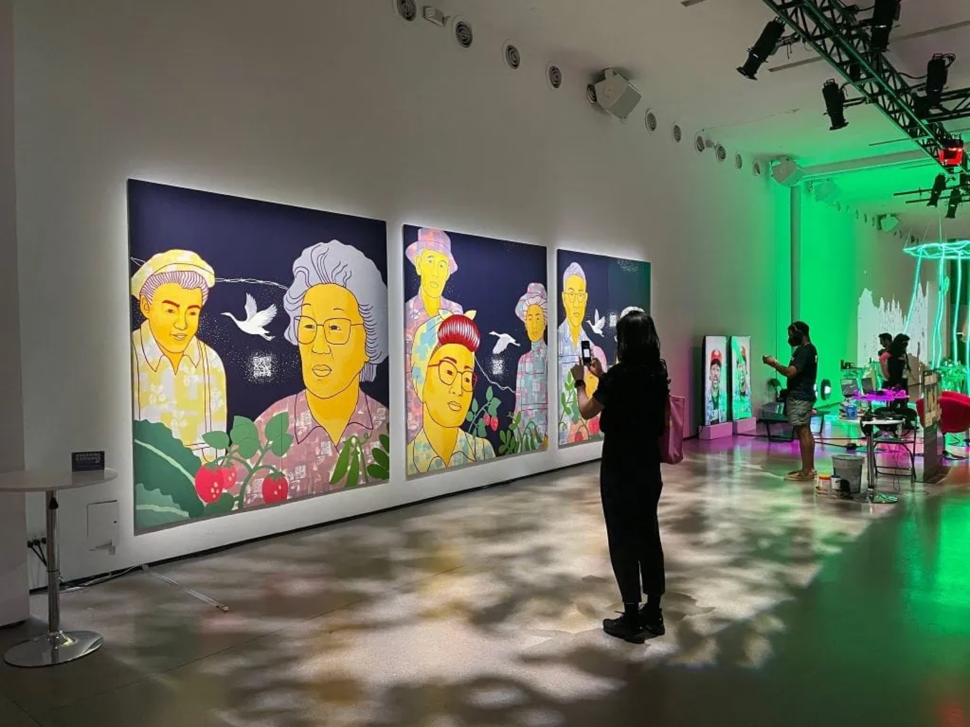 Visitors experiencing the Emerging Radiance mural in a gallery