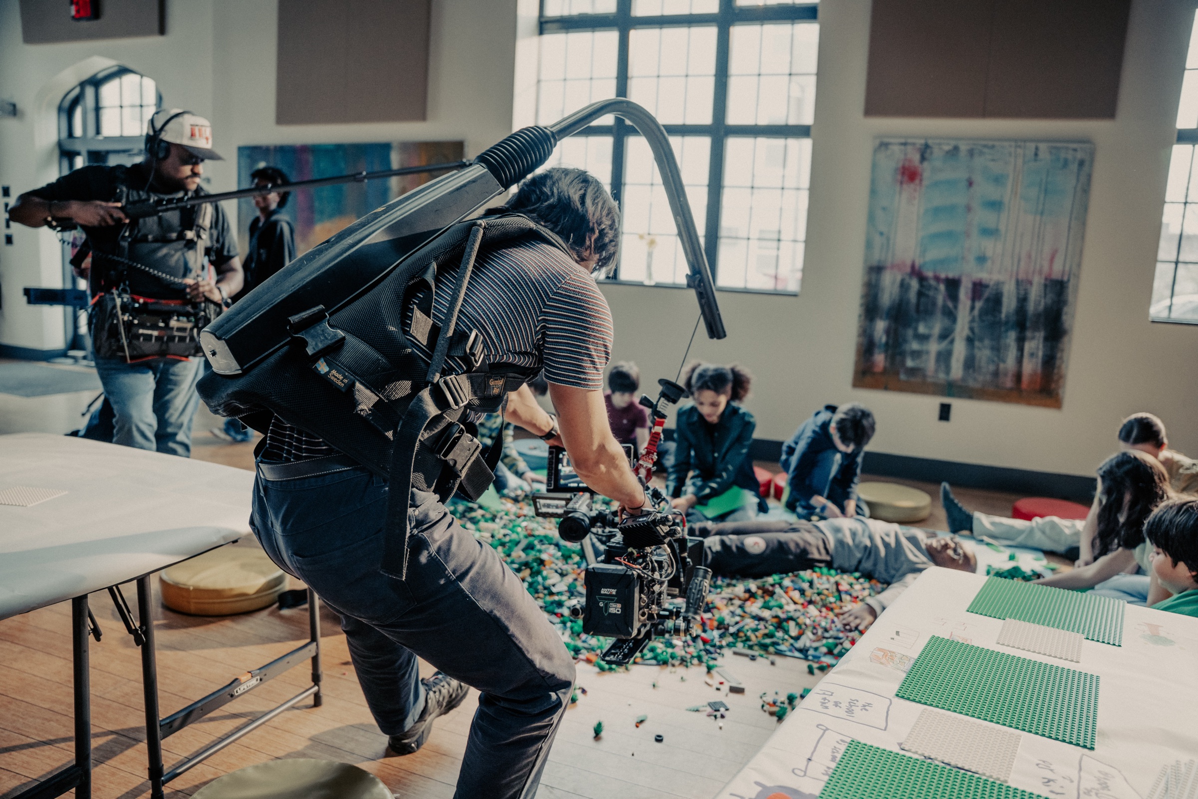 Camera team filming children playing with LEGO bricks